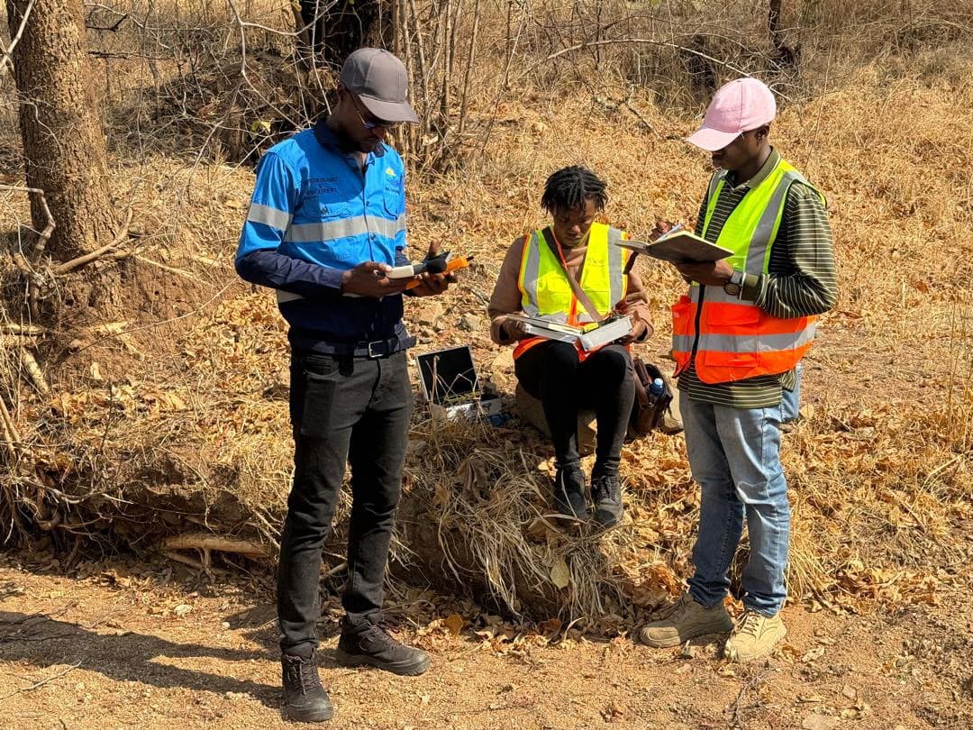Three Altoro team members examining information during fieldwork